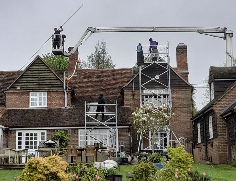 The Roof Moss Cleaners using cherry picker and scaffolding to clean roof safely and professionally in Carterton, Oxfordshire